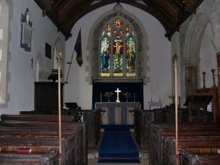 The aisle and altar of the church in Newton St Petrock. 